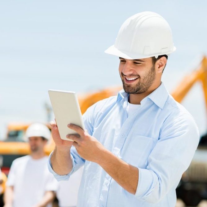 Construction worker using a tablet device
