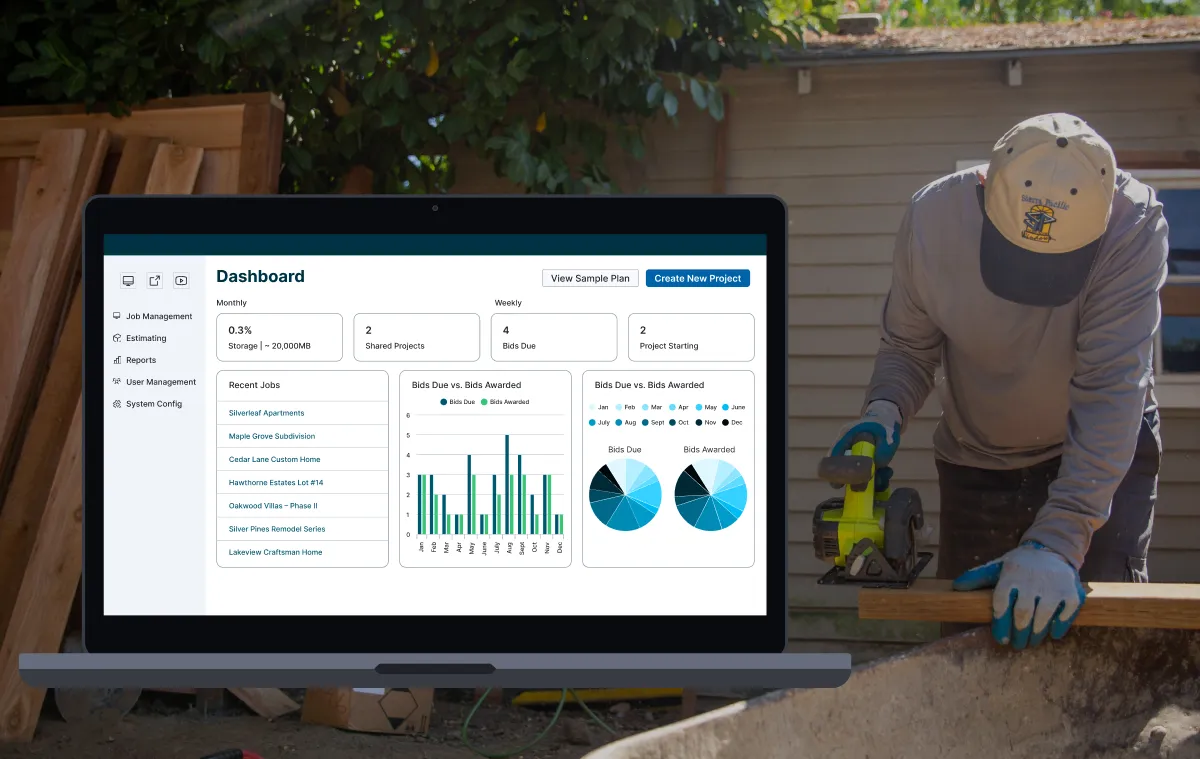Construction worker cutting lumber with a circular saw next to a laptop displaying a construction project management dashboard.